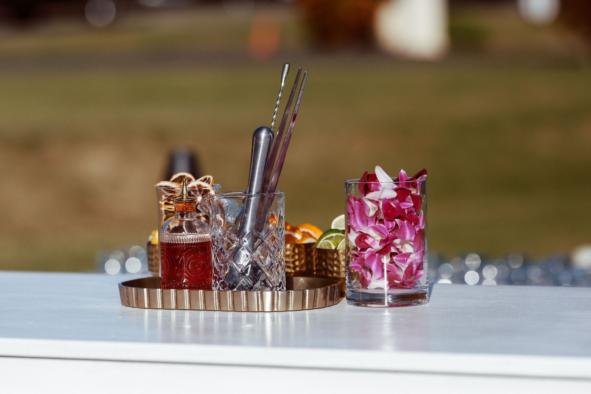 Vibrant Orchid Petals and Fresh Citrus at a Wedding Bar